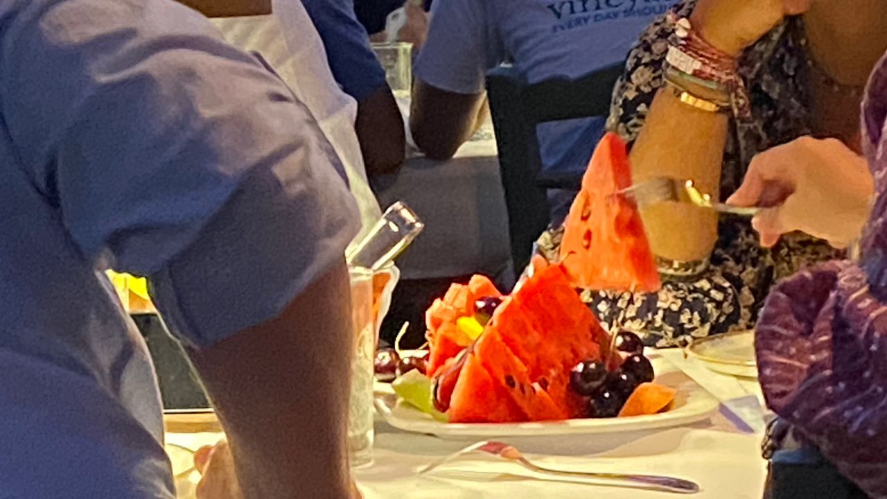 This Greek family ordered a fruit "birthday cake" with a candle they blew out before serving.
