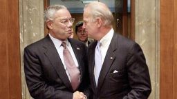 Then-US Secretary of State Colin Powell (L) shakes hands with then-Chairman of the US Senate Foreign Relations Committee Joe Biden, D-DE, 26 September 2002 on Capitol Hill in Washington, DC, prior to testifying on US policy toward Iraq. 