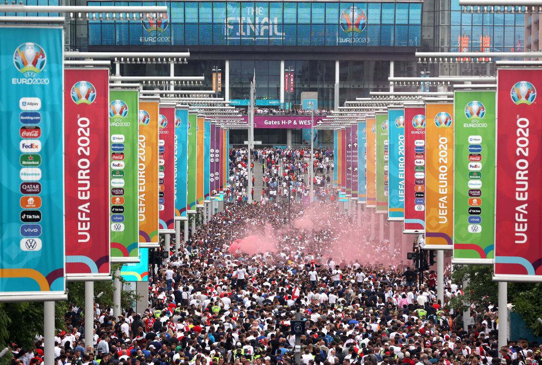Supporters walk down Olympic Way ahead of the Euro 2020 final between Italy and England at Wembley Stadium on July 11, 2021.