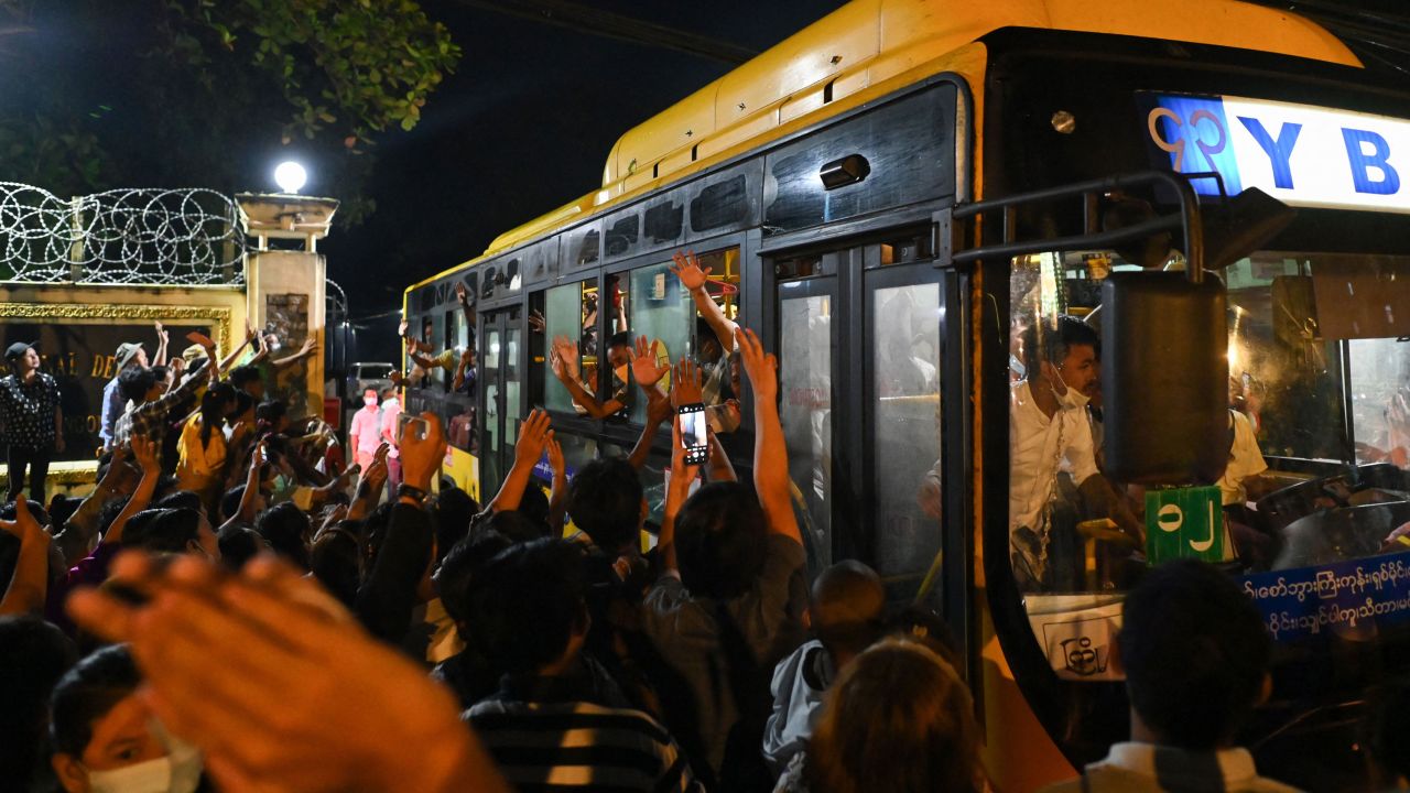 Newly-released prisoners wave from a bus as they depart the Insein Prison in Yangon, Myanmar, on October 18.