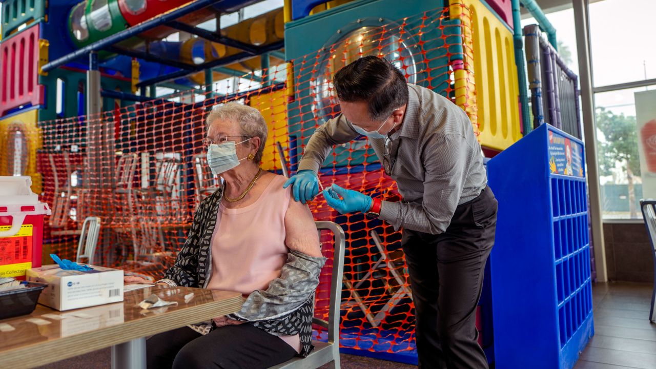 A pharmacist gives a booster shot last month to a senior at a McDonald's in Fullerton, California.