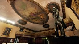 In this July 14, 2010 photo, a statue of Thomas Jefferson, right, stands under the peeling ceiling in New York's City Hall Council Chamber. (AP Photo/Richard Drew)