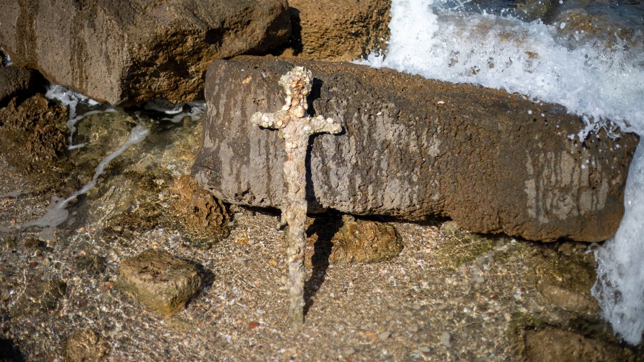 A meter-long (yard-long) sword, that experts say dates back to the Crusaders is on display in the Mediterranean seaport of Cesarea, Israel, Tuesday, Oct. 19, 2021. Israel's Antiquities Authority said Monday a scuba diver was on a weekend dive in northern Israel last Saturday when he spotted a trove of ancient artifacts that included anchors, pottery and the sword. (AP Photo/Ariel Schalit)