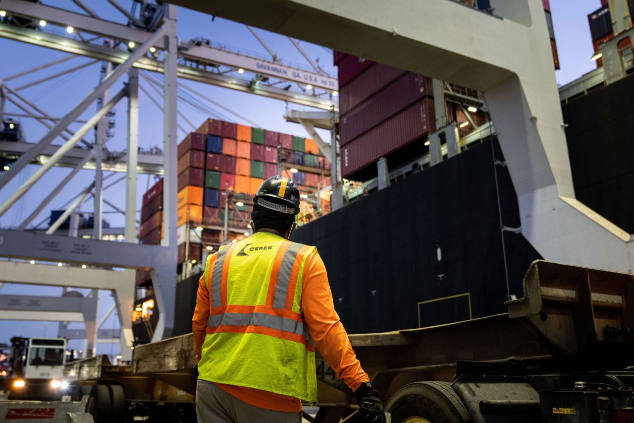 A worker waits for a crane to start moving containers from ship to shore on September 30 at the Port of Savannah in Georgia.