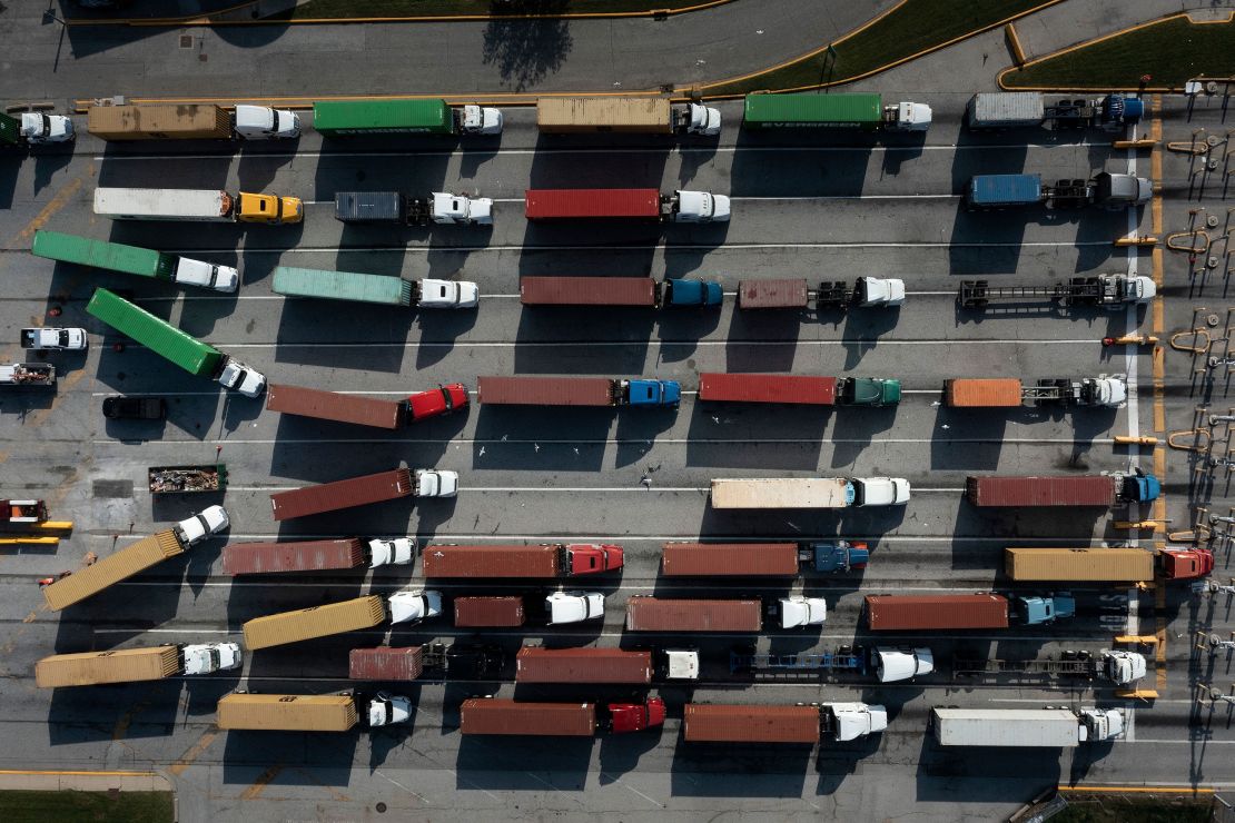 Trucks transport cargo containers, but truckers are hard to come by.