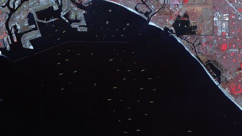 A satellite image captured on Oct. 10, 2021 by NASA shows over 70 ships waiting to dock and unload at the ports of Los Angeles and Long Beach.