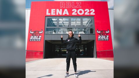 Güldenpfennig posing with a RBLZ Gaming banner with her name.