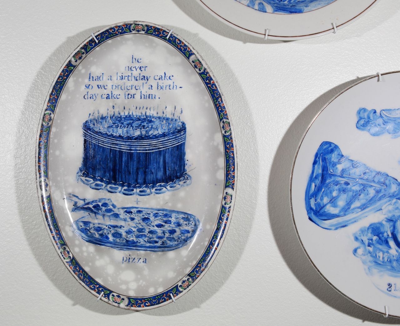 A close up of one of Julie Green's "The Last Supper" plates, showing a birthday cake given to a Death Row inmate.