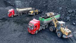 A loader loads coal for transport vehicles at an open-pit coal mine in Ejin Horo Banner, Ordos City, Inner Mongolia, China, Oct. 19, 2021.