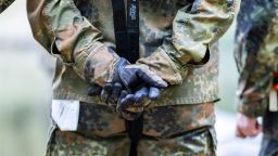 02 October 2021, North Rhine-Westphalia, Mönchengladbach: Bundeswehr soldiers stand together with folded hands at the "Day of Encounter with the Bundeswehr" and 37th International Mönchengladbach Military Competition. Photo: Marcel Kusch/dpa (Photo by Marcel Kusch/picture alliance via Getty Images)