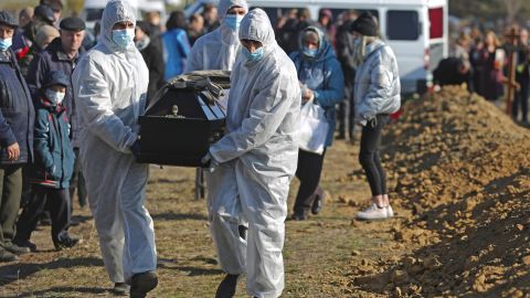 Cemetery workers in protective gear bury people who died of causes related to COVID-19 at Novo-Yuzhnoye Cemetery in Omsk, Russia earlier this month.