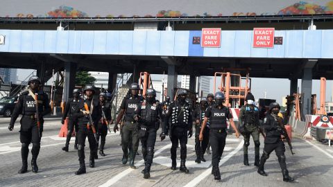 Police officers arrive at the scene of protest during a protest to commemorate one year anniversary of EndSars, a protest movement against police brutality at the Lekki tollgate in Lagos, on October 20, 2021. - Hundreds of youth match to commemorate one year anniversary of Endars protest that rocked the major cities across the country on October 20, 2020. (Photo by PIUS UTOMI EKPEI / AFP) (Photo by PIUS UTOMI EKPEI/AFP via Getty Images)