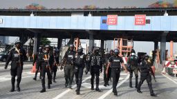 Police officers arrive at the scene of protest during a protest to commemorate one year anniversary of EndSars, a protest movement against police brutality at the Lekki tollgate in Lagos, on October 20, 2021.
