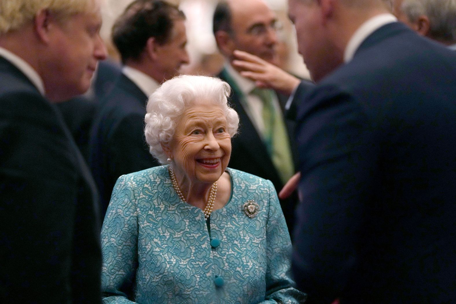 The Queen and British Prime Minister Boris Johnson, left, greet guests during a Windsor Castle reception for international business and investment leaders in October 2021.