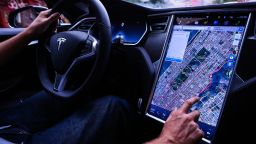 A driver uses the map navigation feature on a touchscreen control panel just prior to the Tesla Motors Inc. 8.0 software update inside a Model S P90D vehicle in New York, U.S., on Monday, Sept. 19, 2016. 