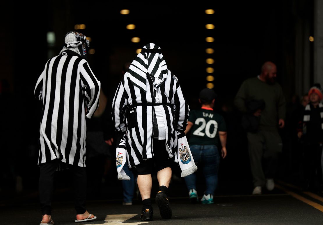 Newcastle United fans pictured wearing mock Arab clothing before the match against Tottenham.