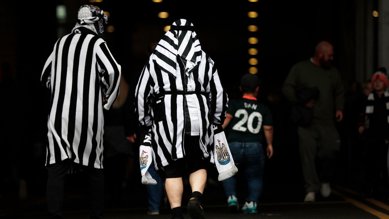 Newcastle United fans pictured wearing mock Arab clothing before the match against Tottenham.