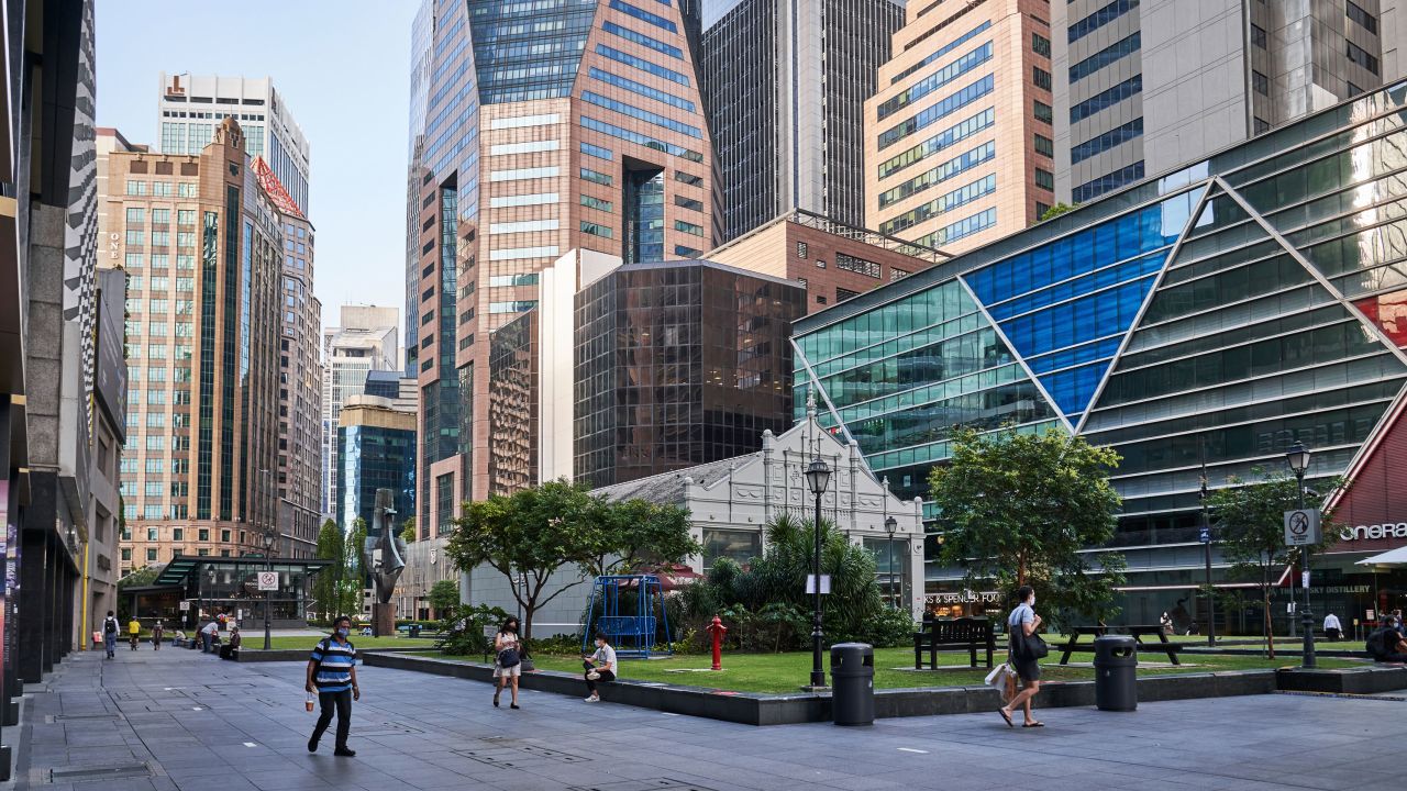 Pedestrians pass through a near empty Raffles Place in the central business district of Singapore, on September 28.