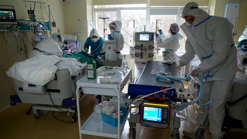 Medics wearing a special suit to protect against coronavirus treat a patient with coronavirus at an ICU at the Moscow City Clinical Hospital 52, in Moscow, Russia, Tuesday, Oct. 19, 2021. Russia hit another daily record of coronavirus deaths Tuesday as rapidly surging infection rates raised pressure on the country's health care system and prompted the government to suggest declaring a nonworking week.(AP Photo/Alexander Zemlianichenko)