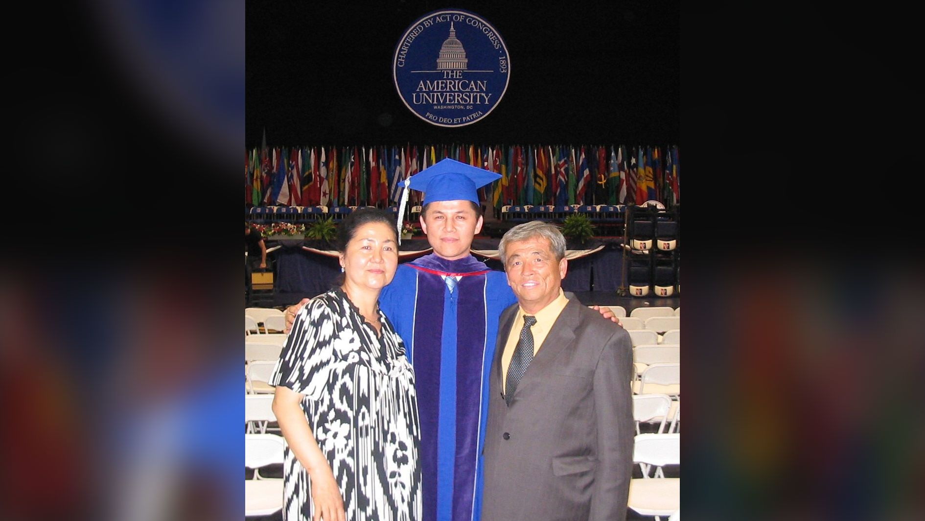 Nury Turkel's parents stand with him at his law school commencement in May 2004.