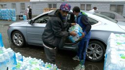 Residents of Benton Harbor, Michigan pick up bottle water distributed by the state. 