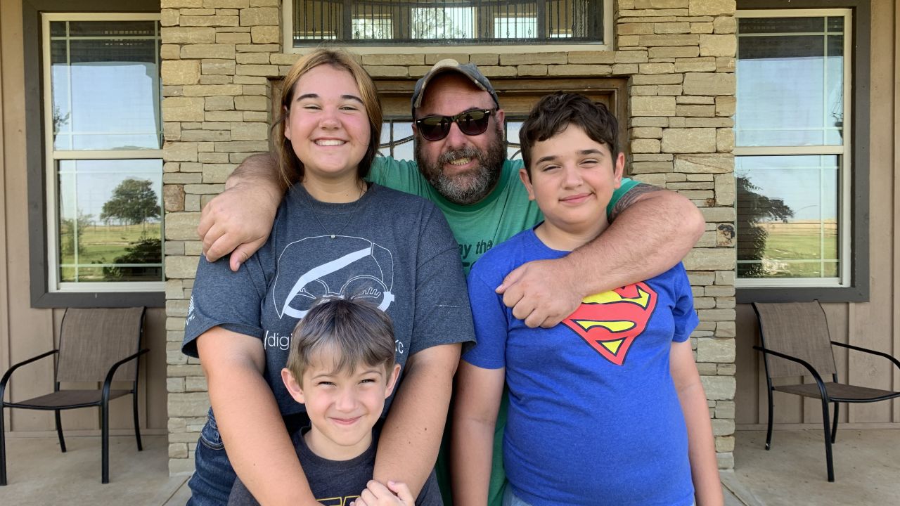 Author and stay-at-home dad Shannon Carpenter (center) is seen with his children (from left): daughter Vivi, younger son Oliver and older son Wyatt.