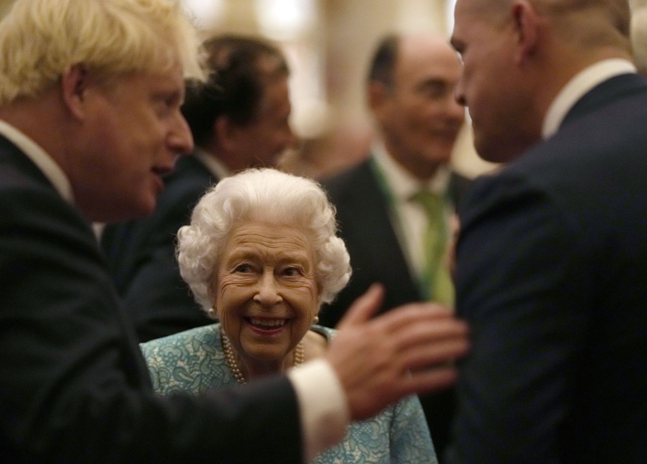 <a href="https://www.cnn.com/2021/10/20/uk/queen-elizabeth-rest-intl-gbr/index.html" target="_blank">Queen Elizabeth II</a> greets guests with Prime Minister Boris Johnson, left, at a reception for the Global Investment Summit at Windsor Castle on Tuesday, October 19. The 95-year-old UK monarch spent Wednesday night <a href="https://www.cnn.com/2021/10/21/uk/queen-hospital-intl-latam/index.html" target="_blank">at a hospital</a> while undergoing "preliminary investigations," according to a Buckingham palace spokesperson, after abruptly canceling a planned trip to Northern Ireland this week.