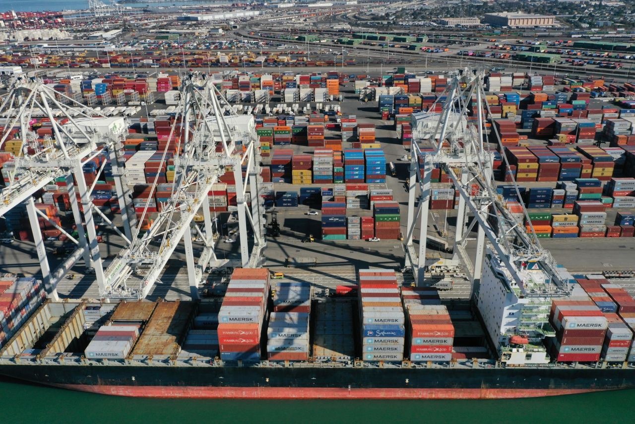 Shipping containers are loaded onto a ship at the port of Oakland in California, on October 14. Around the world, <a href="https://www.cnn.com/2021/10/18/business/container-port-record-backlog/index.html" target="_blank">ports are congested</a> as a result of the rapid rebound in demand for commodities and goods as much of the global economy has recovered from the pandemic.