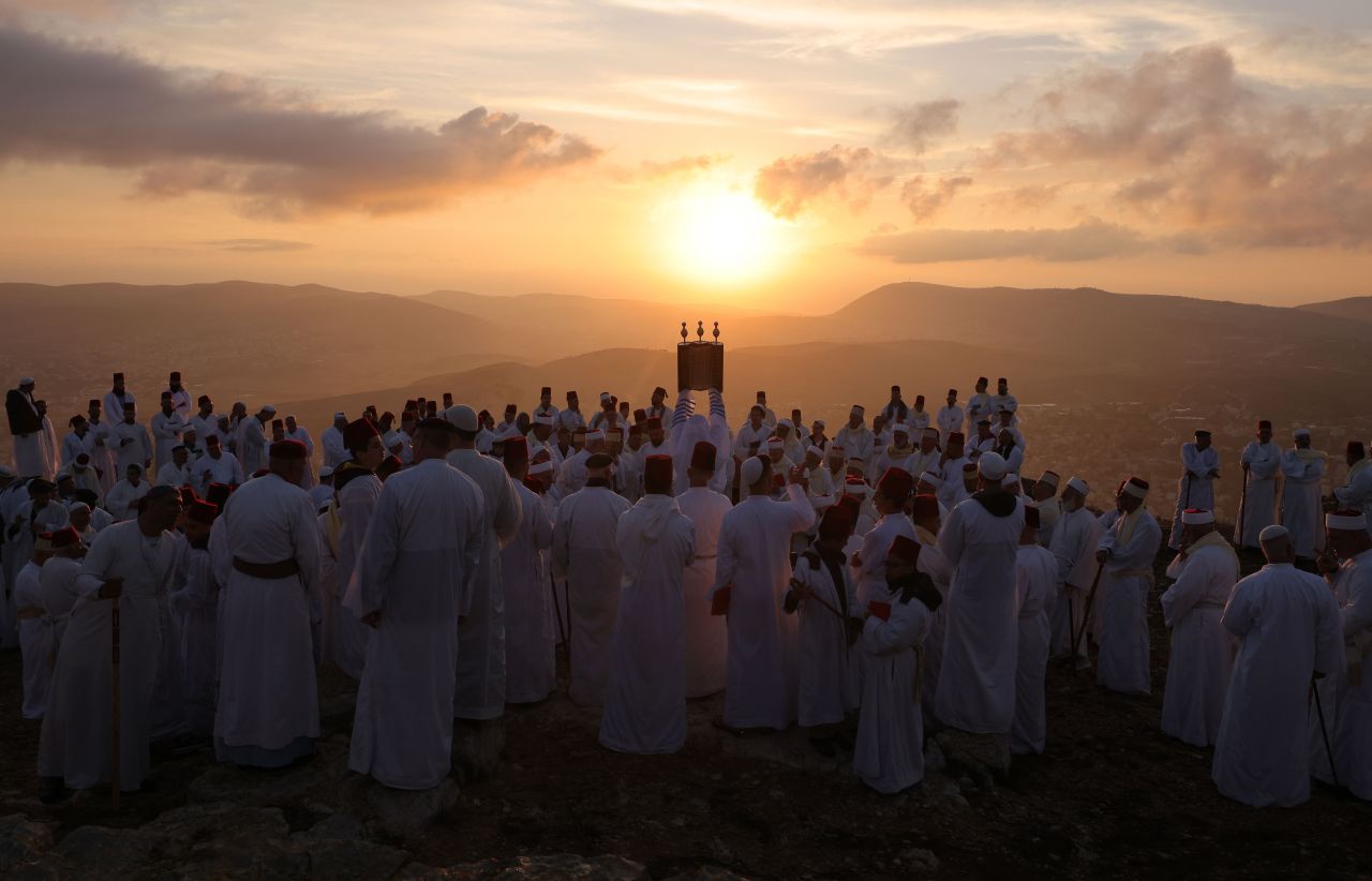 Worshippers hold a Torah during a pilgrimage marking Sukkot on top of Mount Gerizim in the city of Nablus in the West Bank on October 20.