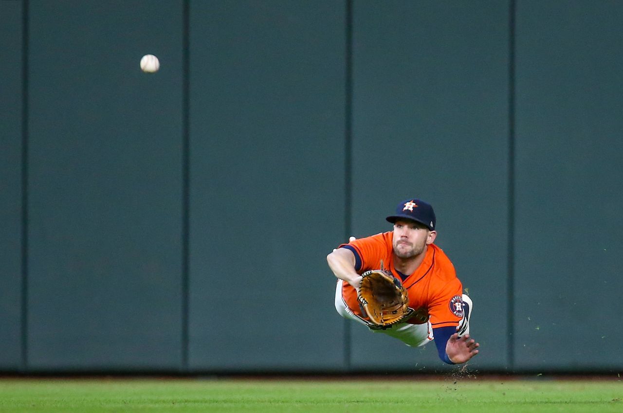 Houston Astros' Chas McCormick dives and catches a ball during game two of the American League Championship Series in Houston on Saturday, October 16.