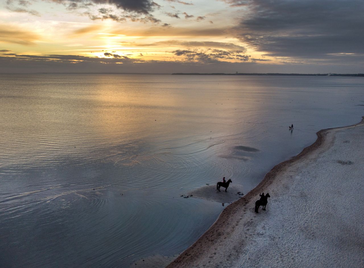 Riders take pictures of each other on the beach in Scharbeutz, Germany, on Sunday, October 17. <a href="https://www.cnn.com/2021/10/14/world/gallery/photos-this-week-october-7-october-14/index.html" target="_blank">See last week in 33 photos.</a>