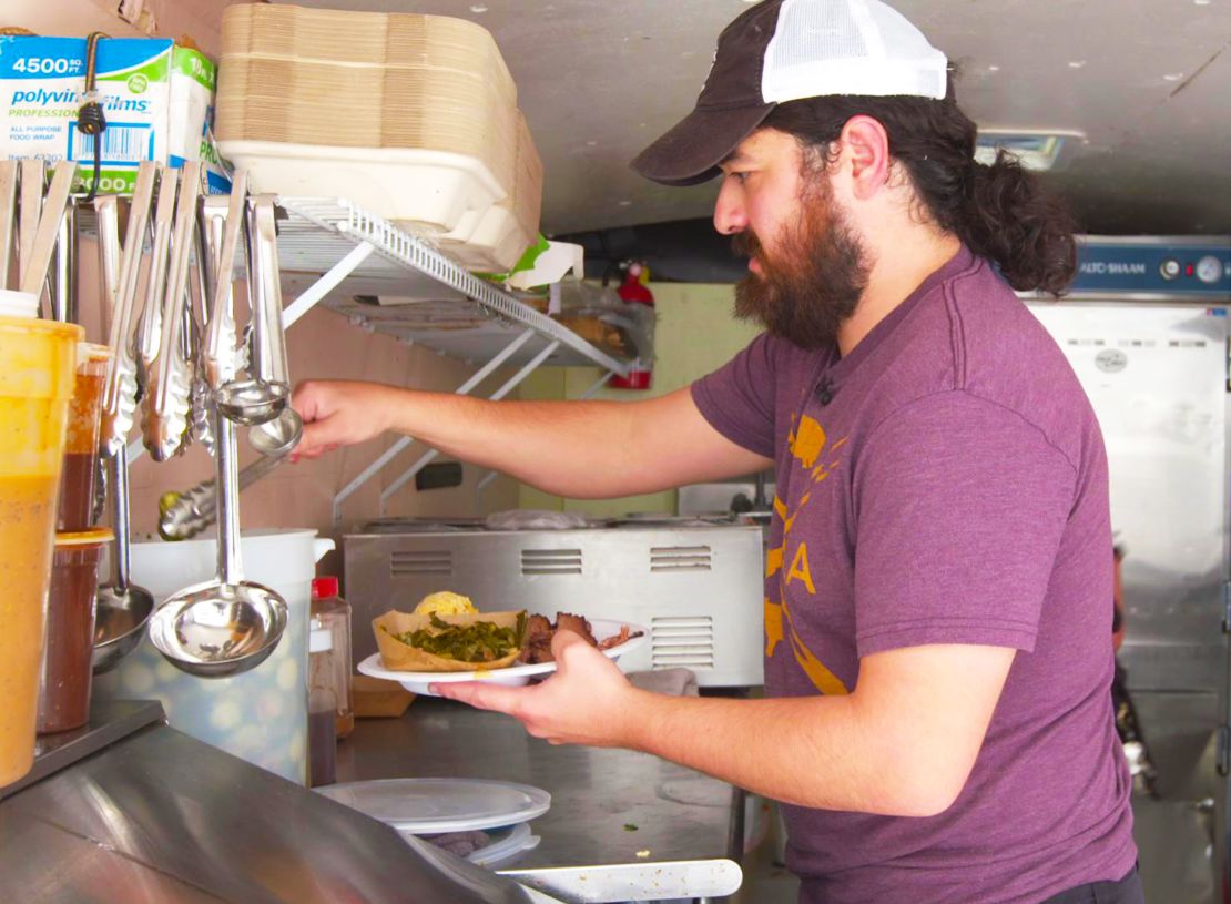 Alex Barbosa preps a plate of barbecue in his mobile barbecue trailer Barbosa's Barbeque.