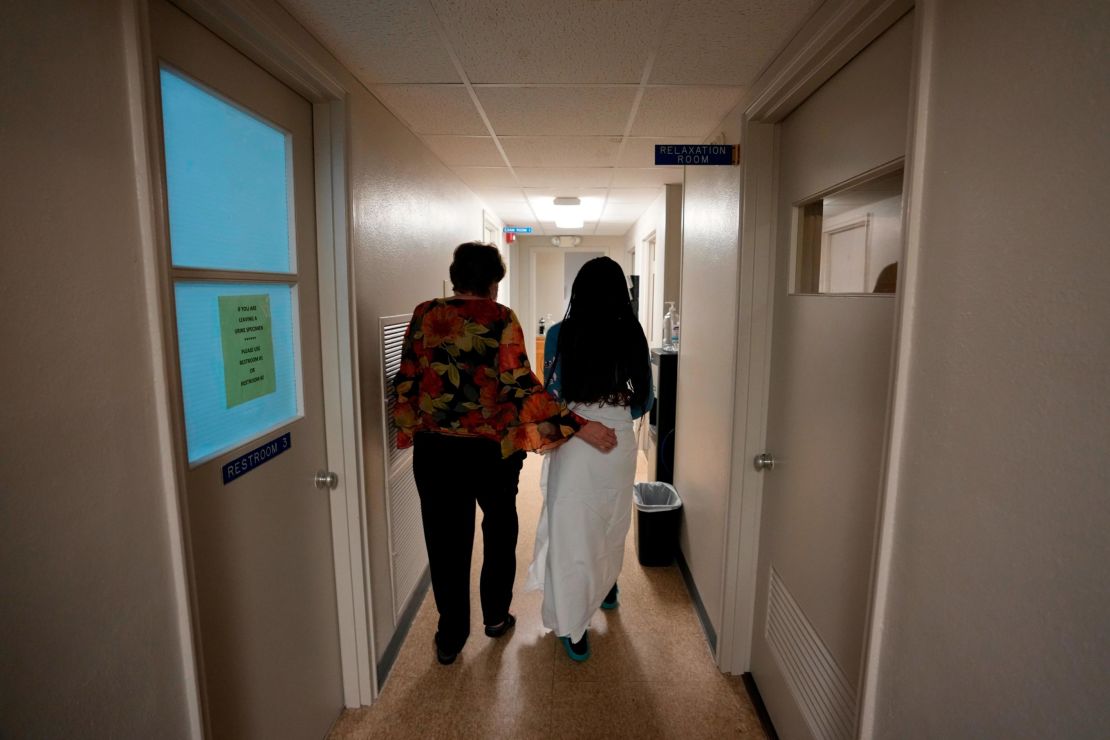 A 33-year-old mother of three from central Texas is escorted down the hall by a clinic administrator prior to getting an abortion on October 9 at Hope Medical Group for Women in Shreveport, Louisiana. 