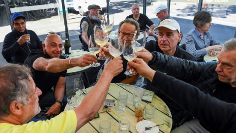 People enjoy a drink at a busy Lygon Street cafe in Melbourne on October 22, following the midnight lifting of coronavirus restrictions in one of the world's most locked-down cities.