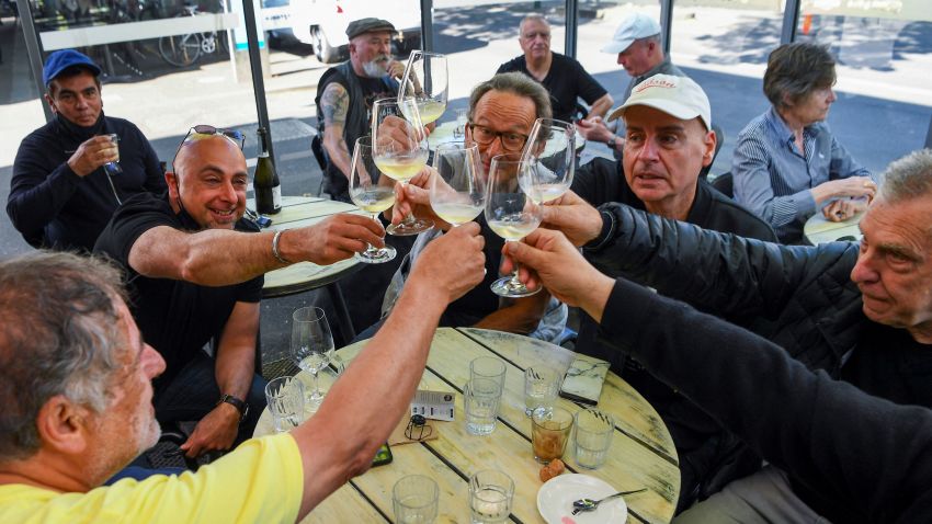 People enjoy a drink at a busy Lygon Street cafe in Melbourne on October 22, 2021, following the midnight lifting of coronavirus restrictions in one of the world's most locked-down cities. (Photo by William WEST / AFP) (Photo by WILLIAM WEST/AFP via Getty Images)