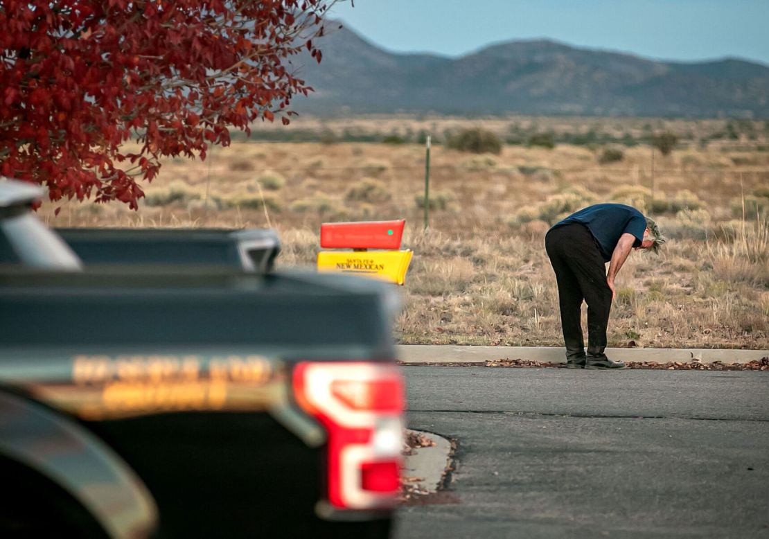 A distraught Alec Baldwin lingers in the parking lot outside the Santa Fe County sheriff's offices after being questioned Thursday about a shooting on a local movie set.