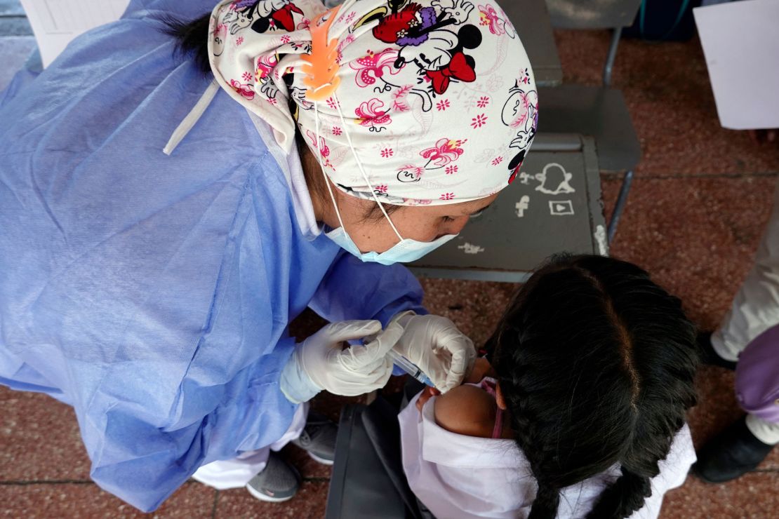 Prepare ahead of time so you can ease your child's fears about getting vaccinated.  A child receives the Covid-19 vaccine in Quito, China, October 18.