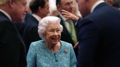 The Queen greets Britain's Prime Minister Boris Johnson, left, during a reception to mark the Global Investment Summit, at Windsor Castle on October 19, 2021.
