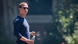 Mark Zuckerberg, chief executive officer and founder of Facebook Inc., holds his phone after the morning session at the Allen & Co. Media and Technology Conference in Sun Valley, Idaho, U.S., on Friday, July 13, 2018. The 35th annual Allen & Co. conference gathers many of America's wealthiest and most powerful people in media, technology, and sports. 