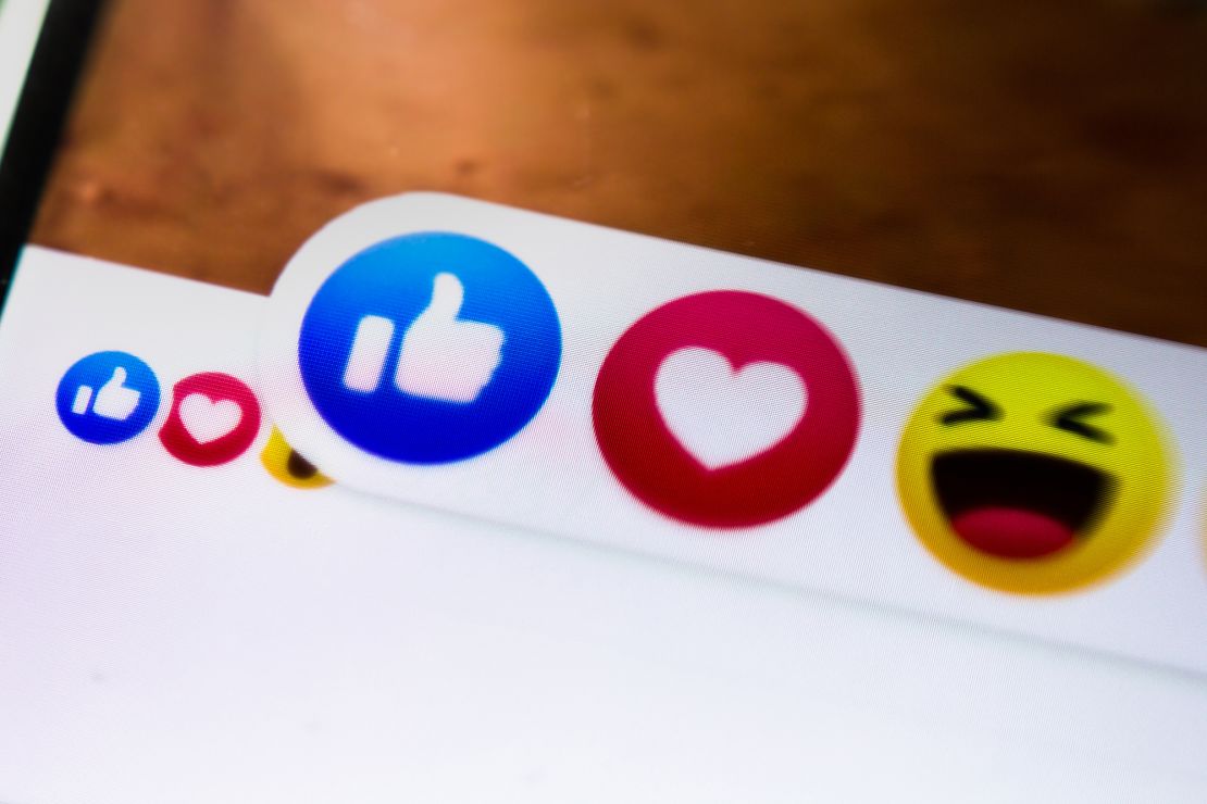 Close-up of Facebook reaction icons shown on a smartphone.