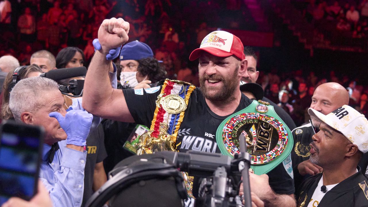 Fury wears his championship belts after defeating Wilder earlier this year.