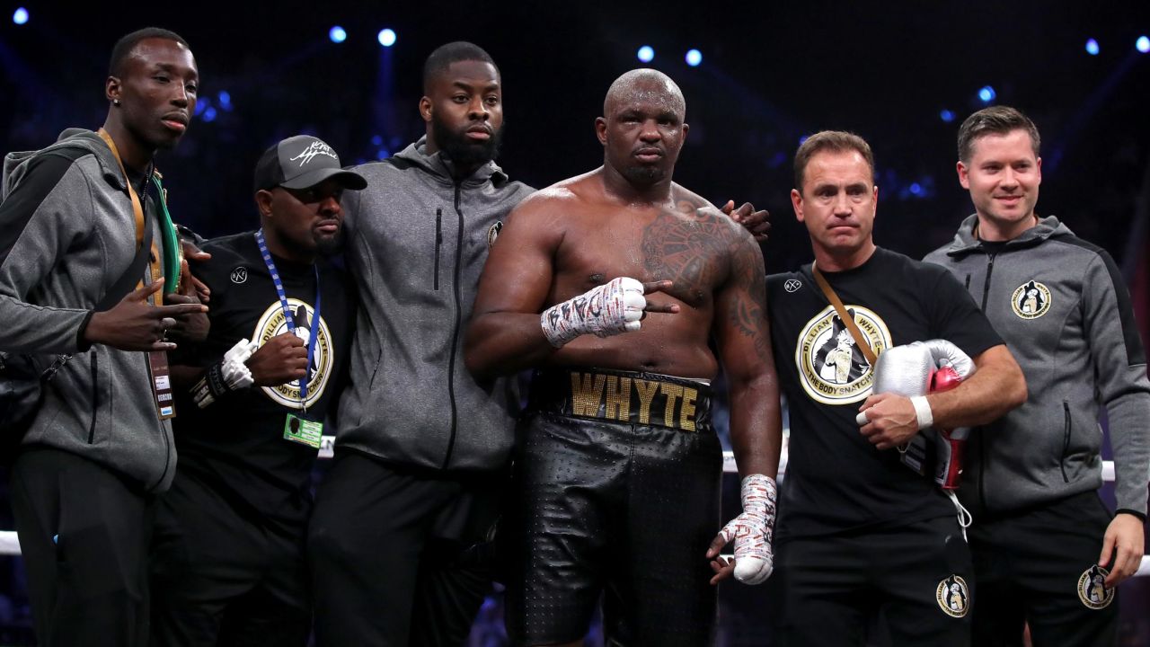 Whyte (center) celebrates beating Mariusz Wach in Saudi Arabia in 2019.