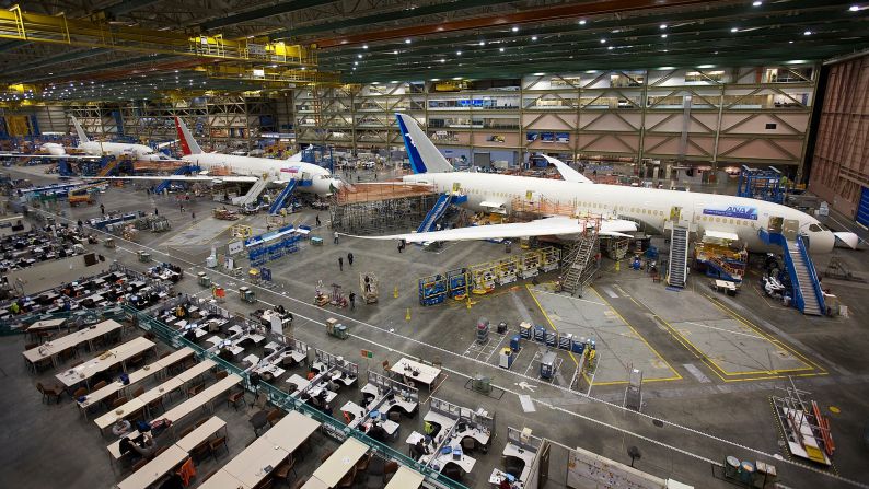 <strong>Eight years in development: </strong> Boeing employees work on a Dreamliner on one of the company's assembly lines in Everett, Washington, ahead of the long-awaited first delivery. 