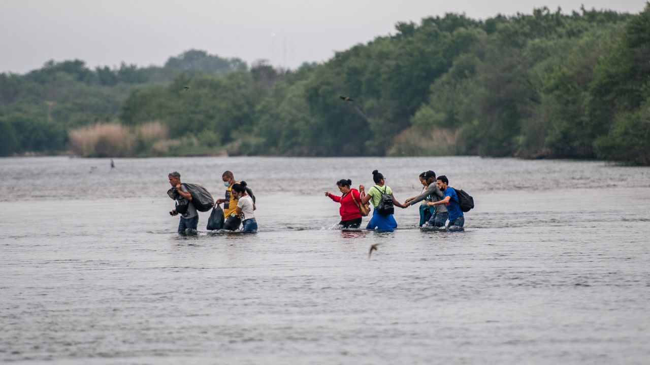 Migrants cross the Rio Grande into the US at Del Rio, Texas, last May. Texas says action is needed to protect its citizens.