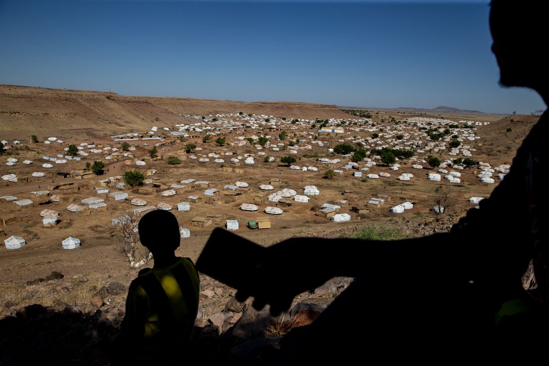 A Tigrayan man looks for cellular service on a mountain overlooking Um Rakuba refugee camp in eastern Sudan in January.