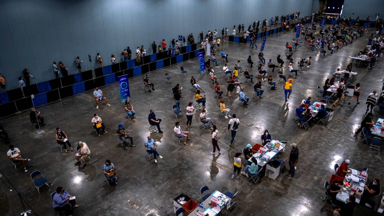 People attend first mass vaccination event at the Puerto Rico Convention Center in San Juan on March 31, 2021.