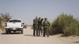 U.S. Border Patrol agents capture a migrant near the U.S. and Mexico border fence in Calexico, California, on September 14, 2021.