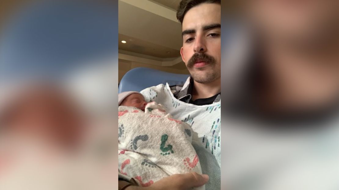 Eric Robison holding his daughter, Carmen.