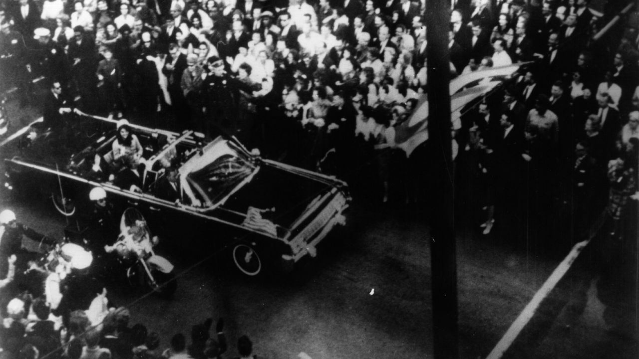 John F. Kennedy, 35th president of the US, and his wife Jackie Kennedy travelling in the presidential motorcade at Dallas, before his assassination.  