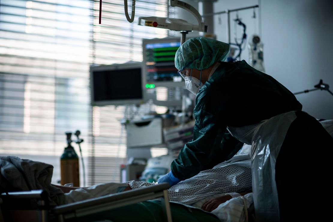 A health care and nursing assistant stands in the Covid-19 intensive care unit at Essen University Hospital, Germany. 